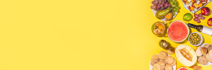 Buon Ferragosto (happy in italian language) holiday background. Summer Italian harvest festival August 15  brunch, family party antipasto foods with watermelon, melon, grapes, cheese, snacks, drinks