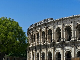 Fototapeta premium Nîmes, May 2023 : Visit the beautiful city of Nîmes en Provence - Historical city with its arena and ancient theater - View on the arena