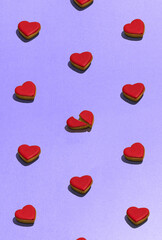 Cookies in the shape of heart on dessert top view. Food pattern with sweet bakery over violet background flat lay top-down composition. Find the difference