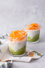 Healthy breakfasts and lunches, avocado and yogurt with chia, grated carrots and radishes in glass cups