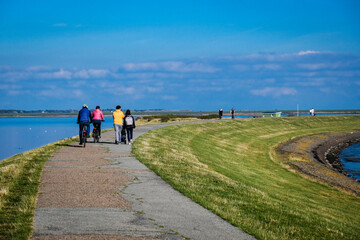 Fußganger auf dem Deich des Rantumer Beckens auf Sylt