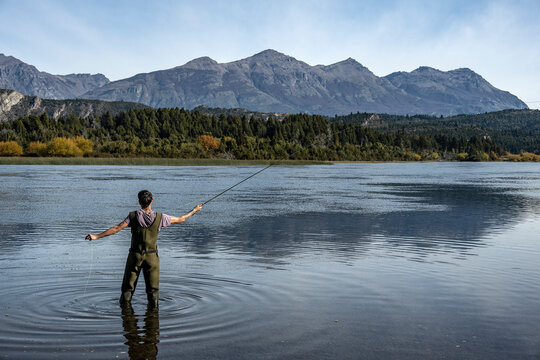 Young man practices sport fly fishing in the Rio Grande or Futaleuf&uacute;, in Chubut, Patagonia Argentina.