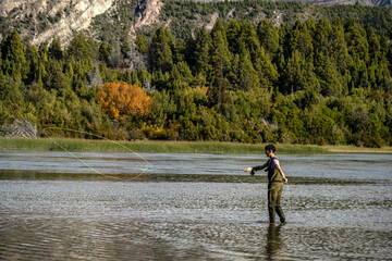 Young man practices sport fly fishing in the Rio Grande or Futaleufú, in Chubut, Patagonia...