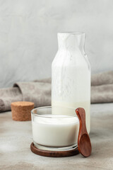 homemade yogurt, kefir, fermented milk on a light background. Healthy, clean eating. Vegan or...