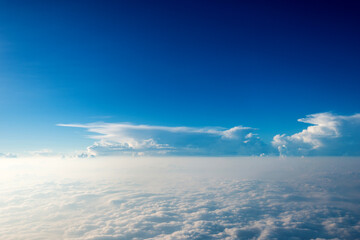 Blue sky and white cloud from airplane window