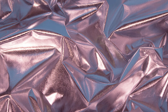 Abstract pink crumpled foil background. Minimal party concept.