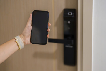 Hand using smartphone for open digital door lock at home or apartment. NFC Technology, Fingerprint...
