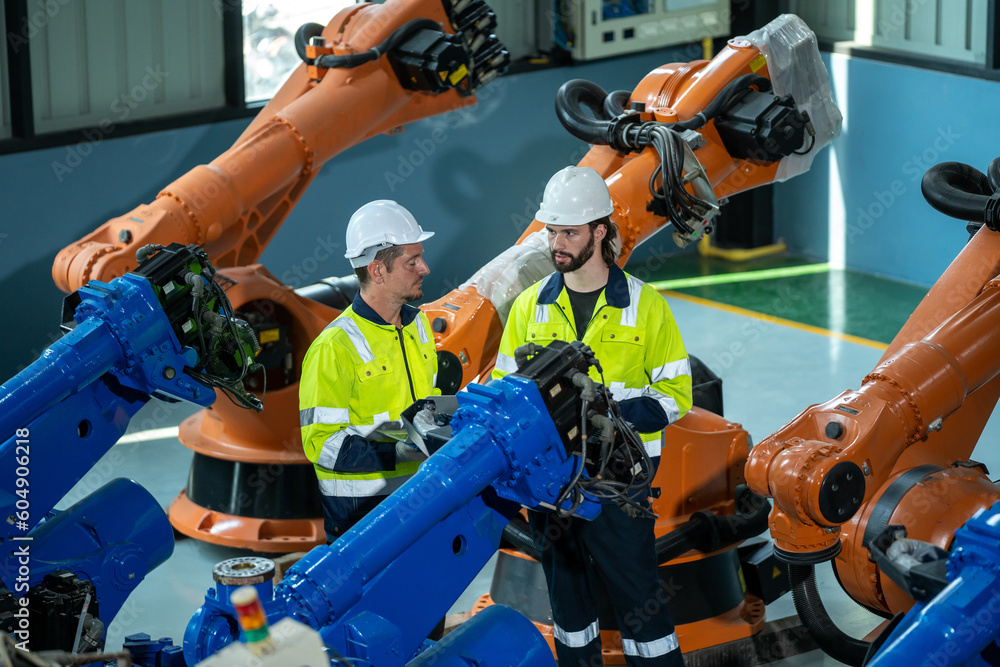 Aufkleber electronics engineer works with robot checking voltage and program response time in production plant