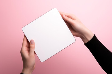white blank notepad in female hands on a pink background generative ai