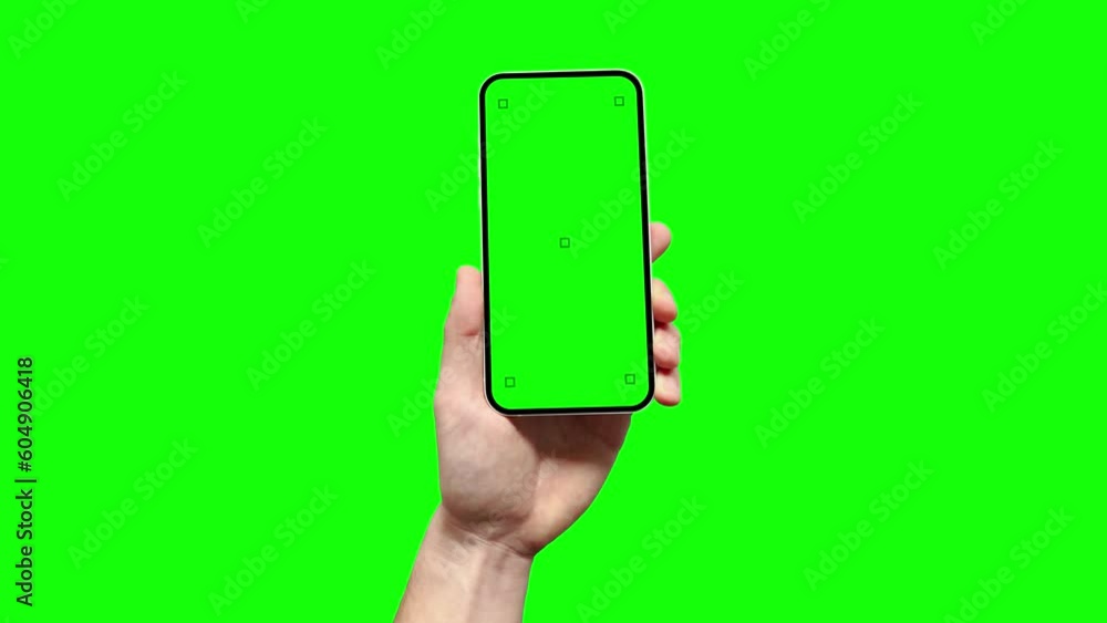 Aufkleber a man is holding a smartphone with a blank green screen featuring tracking marks, and he is touching