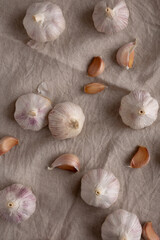 Raw Organic White Garlic Bulbs on a cloth, top view. Flt lay, overhead, from above.