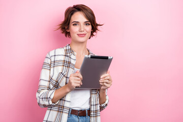 Photo of sweet shiny woman dressed plaid shirt chatting instagram twitter telegram facebook empty space isolated pink color background