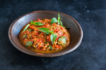 sambel terasi ulek or chili paste in black background
