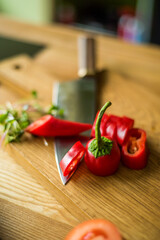 red pepper on a board with a knife