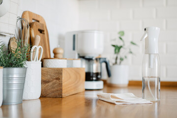 Cleaning spray detergent and dish cloth on kitchen work surface, concept for hygiene