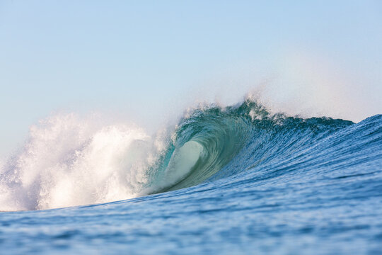 massive powerful wave breaking on a shallow reef in the ocean