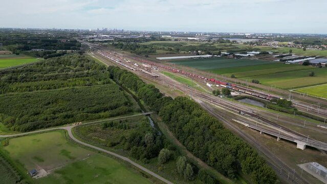This aerial drone video shows the large marshalling yard named the Kijfhoek in Barendrecht, the Netherlands. There are many freight trains and containers on this railway tracks from the port. 