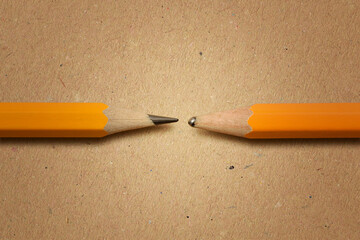Sharpened pencil versus dull pencil on recycled paper background - Concept of innovation and...