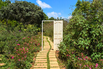 Opened wooden door entrance to the spring summer metaphor