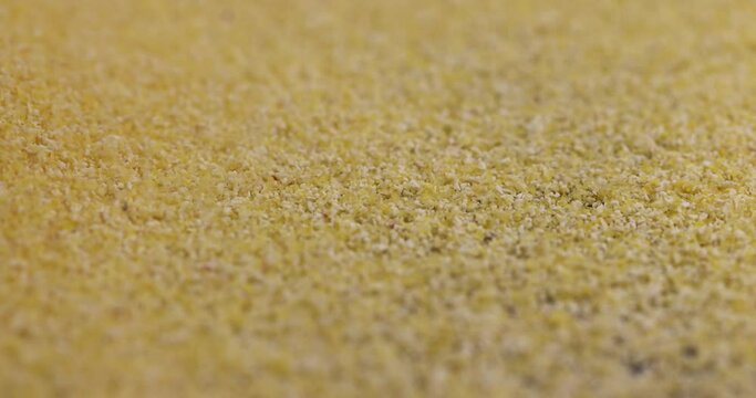 pour yellow corn grain flour for cooking polenta porridge, dry yellow polenta porridge close-up
