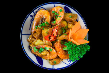 Salt fried shrimp with sauce and vegetables isolated on black backround