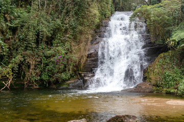 Fototapeta premium Voluminous Waterfall, with natural lake and clear brown water, Bananal, state of Sao Paulo