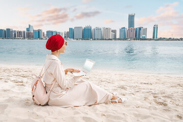 The woman's beach setup is a testament to the growing trend of digital nomadism, with a portable workstation that allows her to work and play from anywhere in the world.