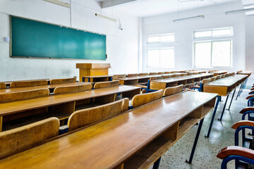 Empty classroom with chairs, desks and chalkboard