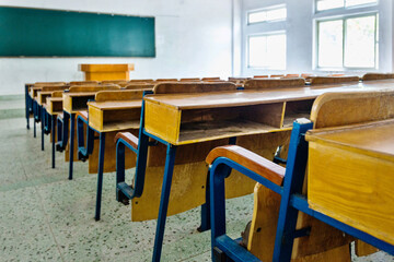 Empty classroom with chairs, desks and chalkboard