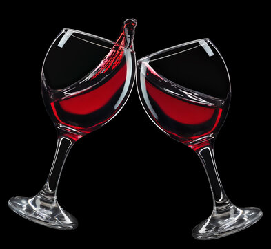 two glasses of red wine in toasting gesture with splash isolated on black