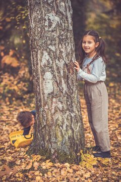 Child in the forest smiling and playing