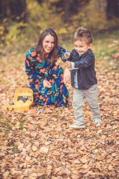 Happy smiling beautiful family playing and laugh in the forest