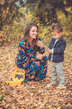 Happy smiling beautiful family playing and laugh in the forest