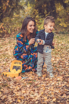 Happy smiling beautiful family playing and laugh in the forest