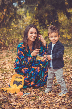 Happy smiling beautiful family playing and laugh in the forest