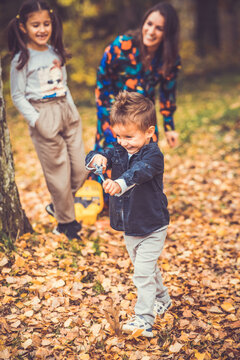 Happy smiling beautiful family playing and laugh in the forest