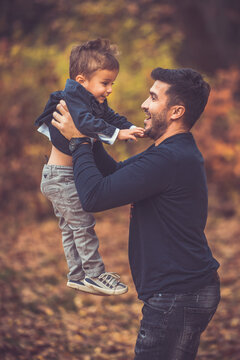 Happy smiling beautiful family playing and laugh in the forest