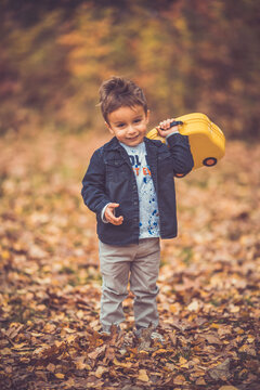 Child in the forest smiling and playing