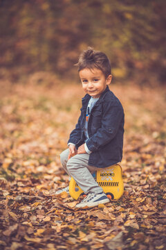 Child in the forest smiling and playing