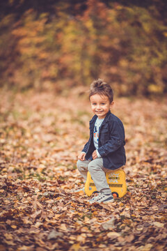 Child in the forest smiling and playing