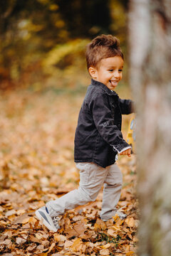 Child in the forest smiling and playing