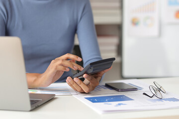 Businesswoman working with laptop and financial documents on desk, financial and investment data analysis, financial planning and accounting.