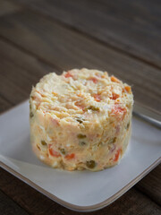 Typical spanish tapa called Russian salad or ensaladilla rusa. Potato salad with tuna and mayonnaise . Close up view, selective focus.