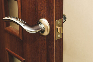 Door handle close-up, door closing mechanism. - obrazy, fototapety, plakaty