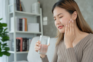 Asian woman feel sensitive teeth after drinking cold, female suffer tooth, decay problems, dental care, tooth extraction, decay problem, bad breath, Gingival Recession, Oral Hygiene instruction
