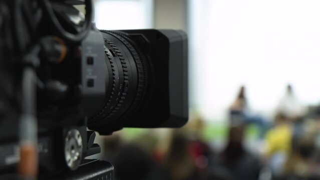 A camera records a group of people - closeup