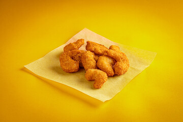 Fried chicken nuggets on a yellow background