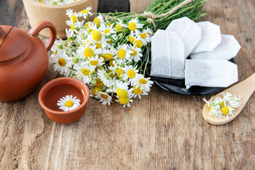 cup of herbal chamomile tea and fresh chamomile, camomile flowers	