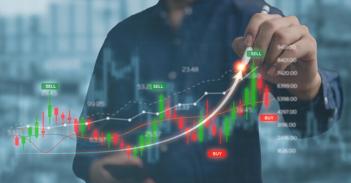 Businessman holding a pen pointing on graph Stock exchange market analysis on a virtual screen. Business and financial investment concept.