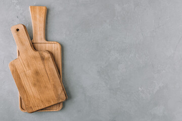 Chopping boards. Empty wooden cutting boards on gray stone background